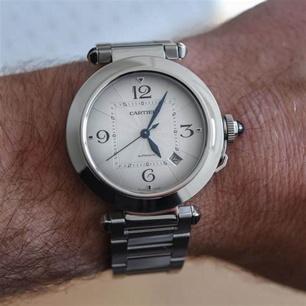 The blue hands are contrasted to the silver dial of fake Cartier.