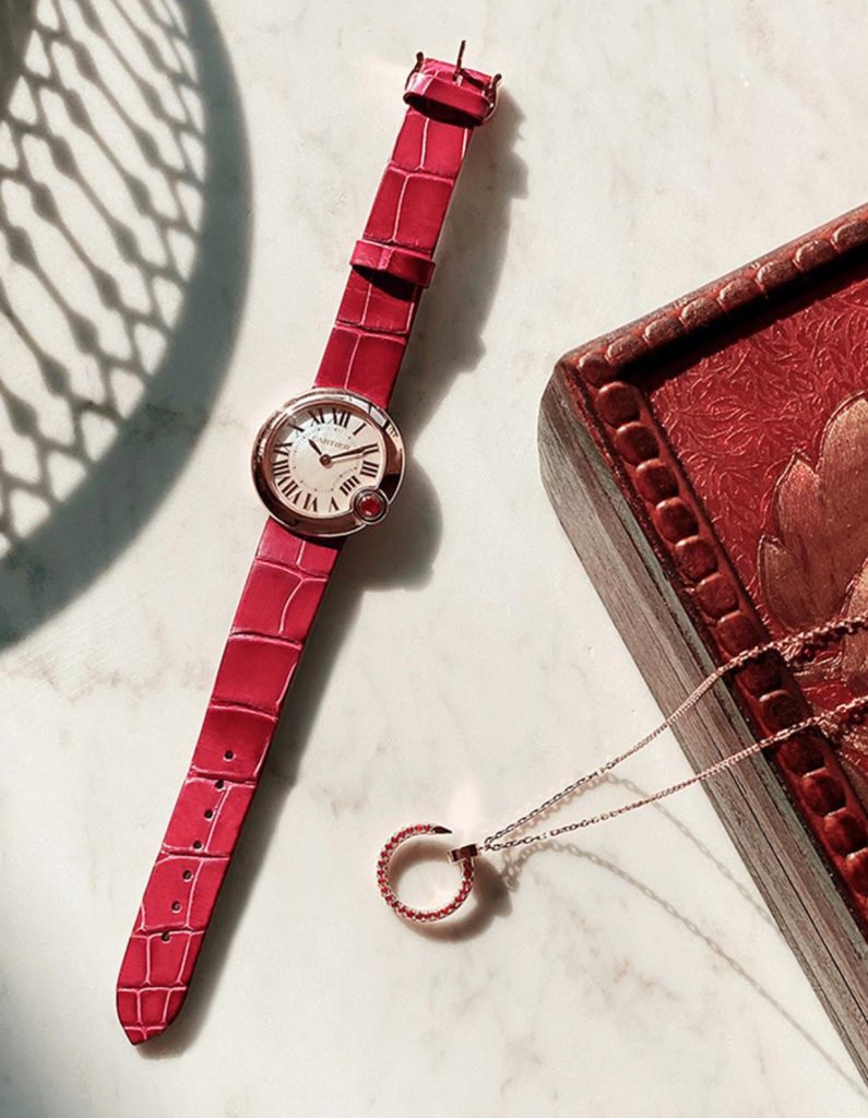 The 18k rose gold fake watch has a red strap.